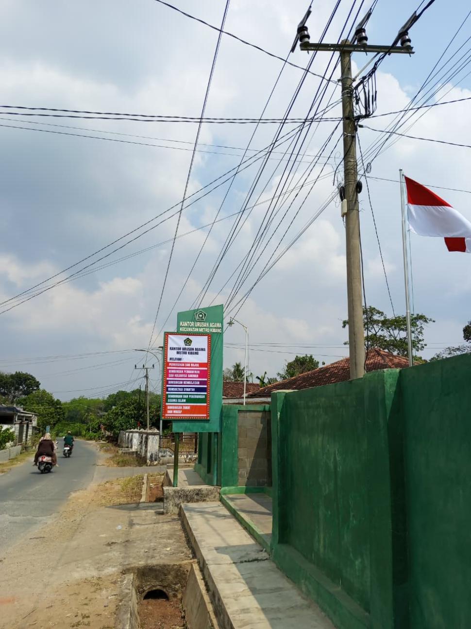 Staf KUA Metro Kibang Laksanakan Pemeliharaan Plang Neonbox Demi Meningkatkan Kualitas Layanan